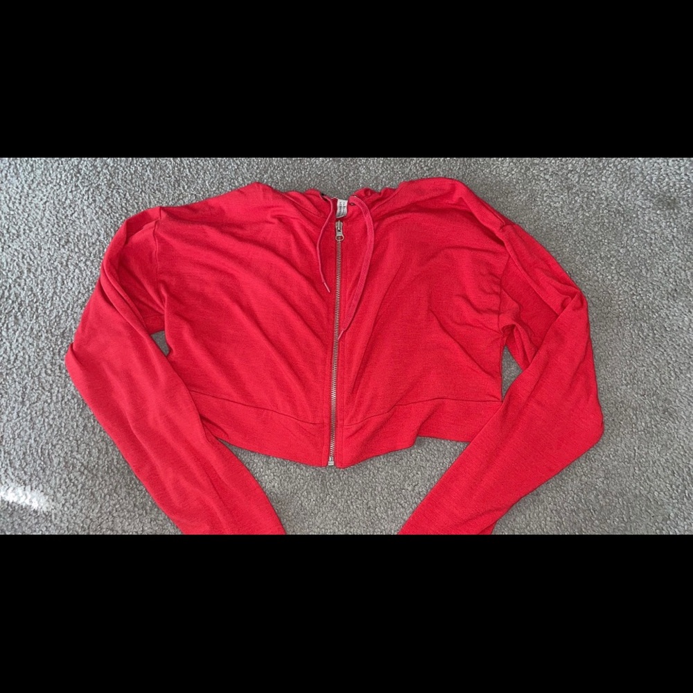 Red cropped zip up sweater.